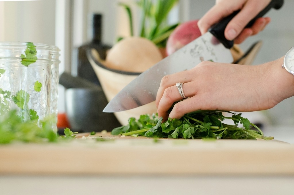 herb-infused recipe prep-chopping culinary herbs on wooden cutting board
