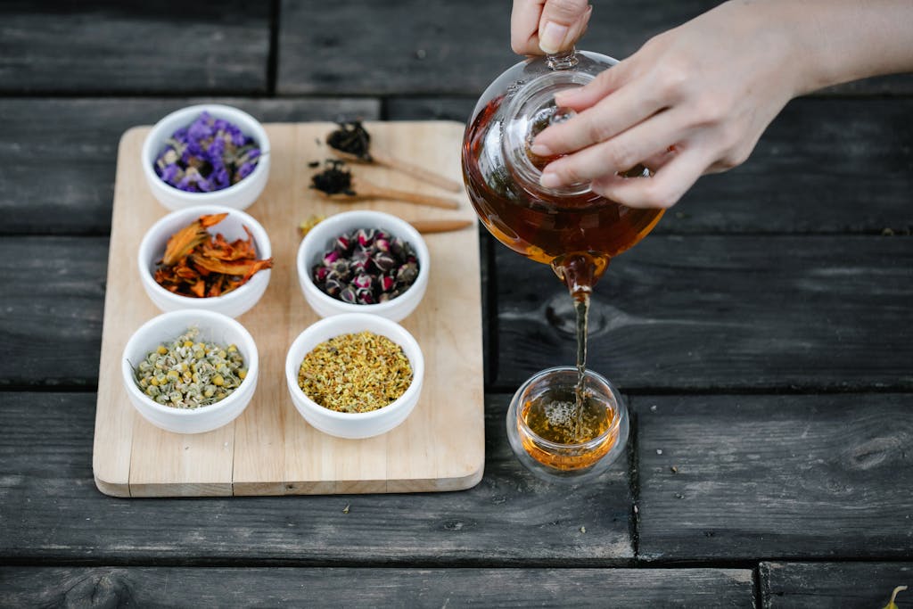 Herbal Wisdom Tea being poured into a Glass Teacup