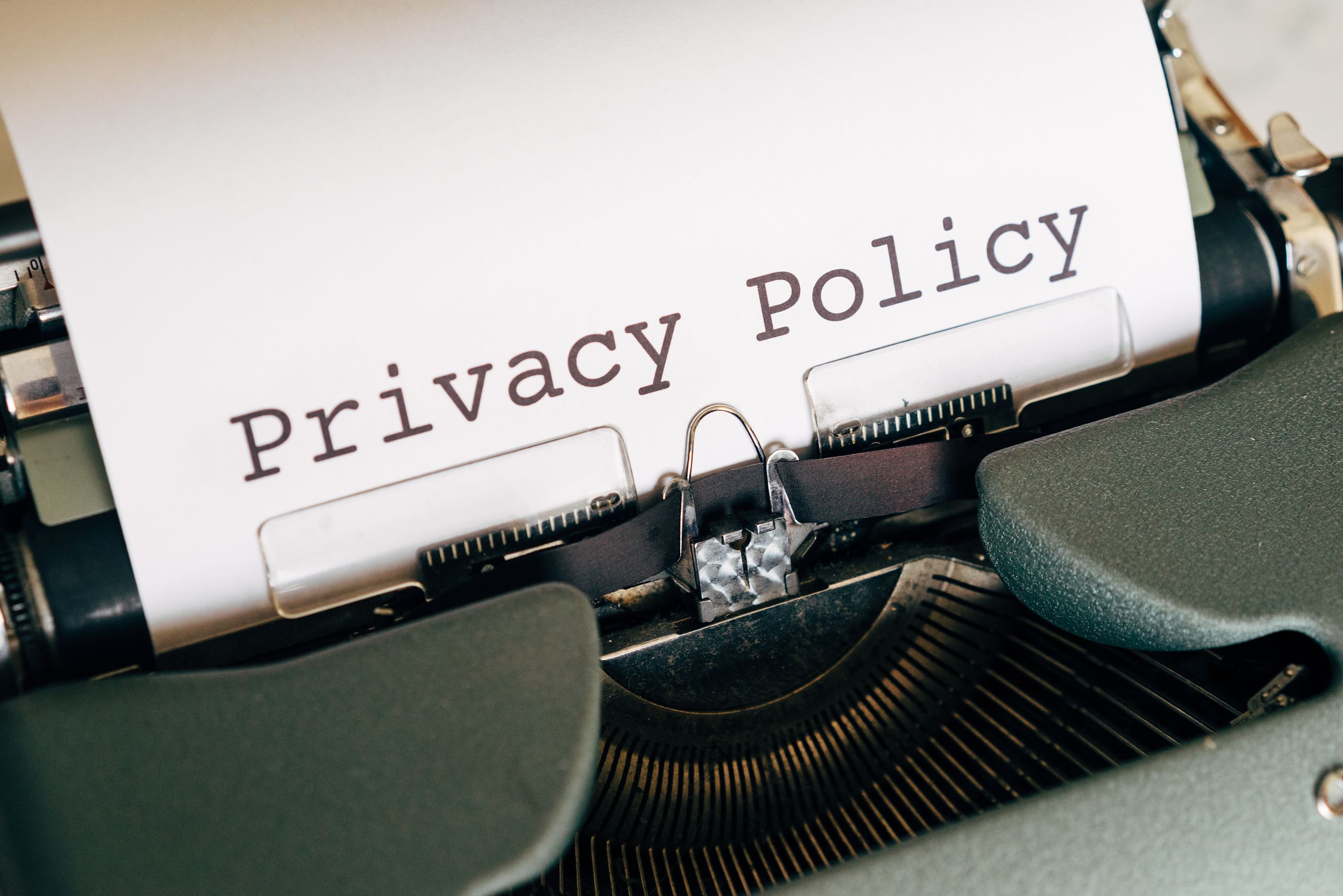 privacy policy A vintage typewriter writing 'Privacy Policy' on paper, capturing an old-school conceptual theme.
